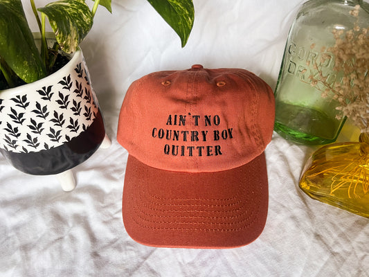 the giver “ain’t no country boy quitter” cap (PREORDER)