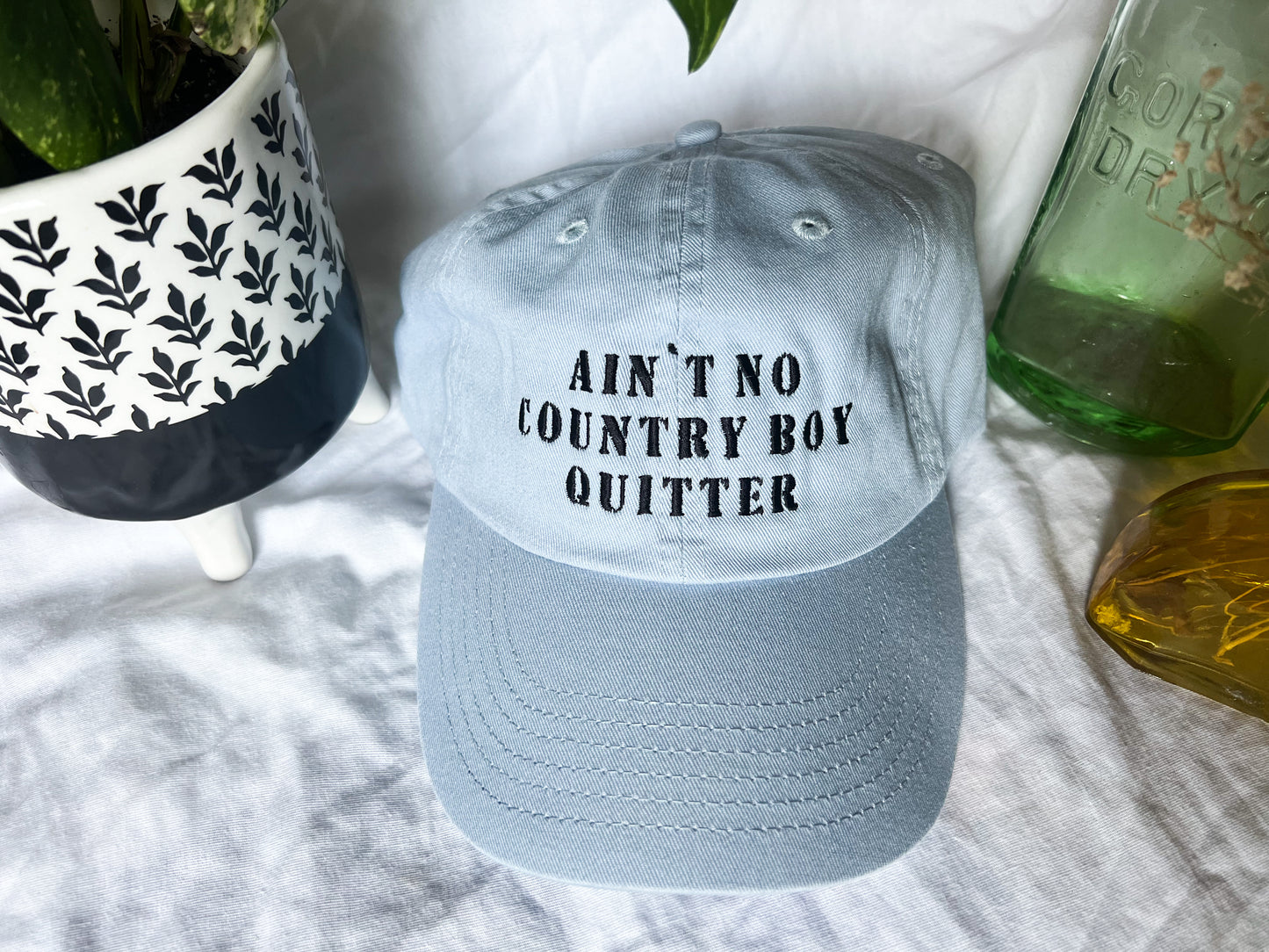the giver “ain’t no country boy quitter” cap (PREORDER)